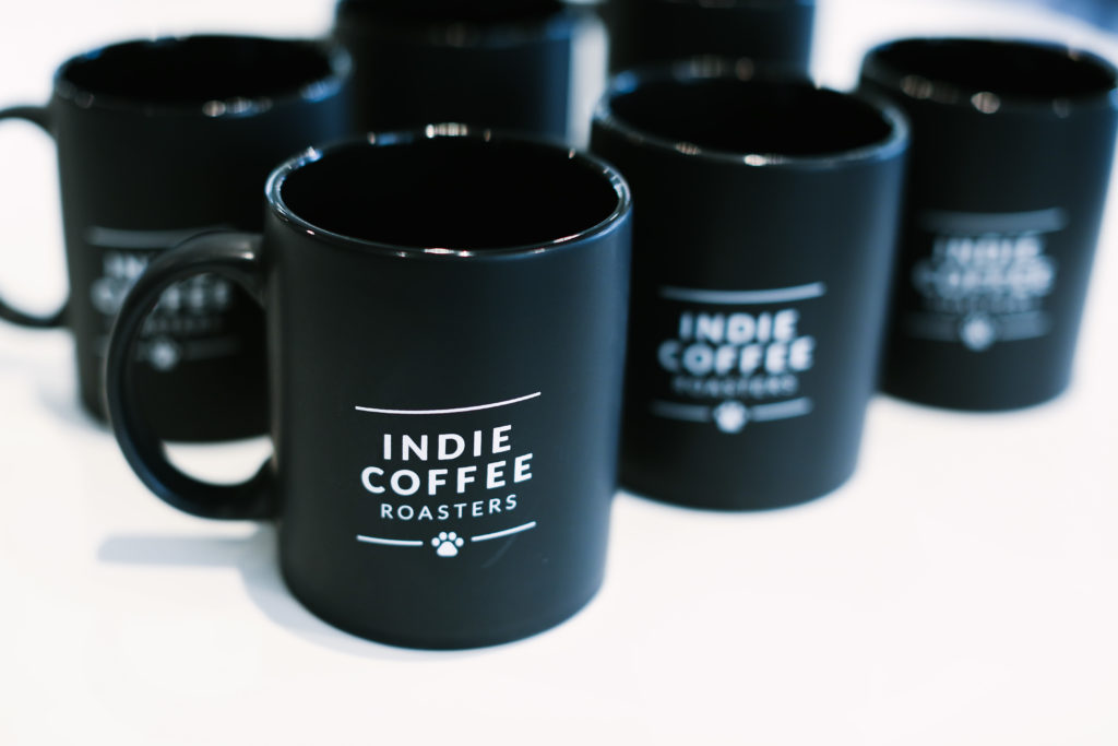 Black cup coffees with white text saying "Indie Coffee Roasters"