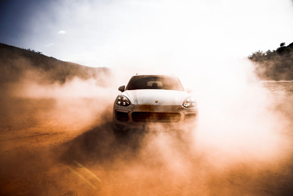 A porches emerges from the dust of the road.