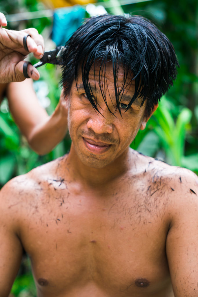 A man gets his haircut. 