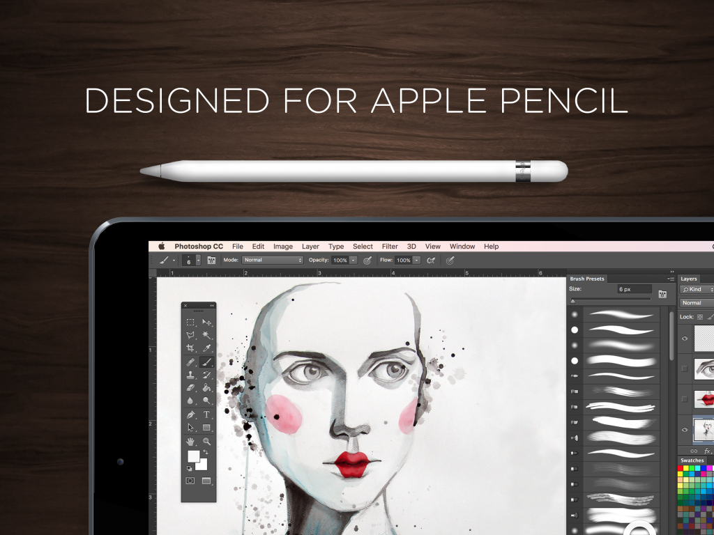 An Apple pencil and tablet lay on a desk. 