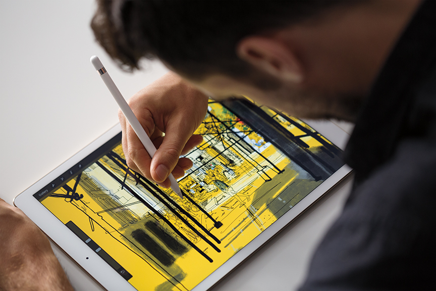 A man draws a street scene on a tablet. 
