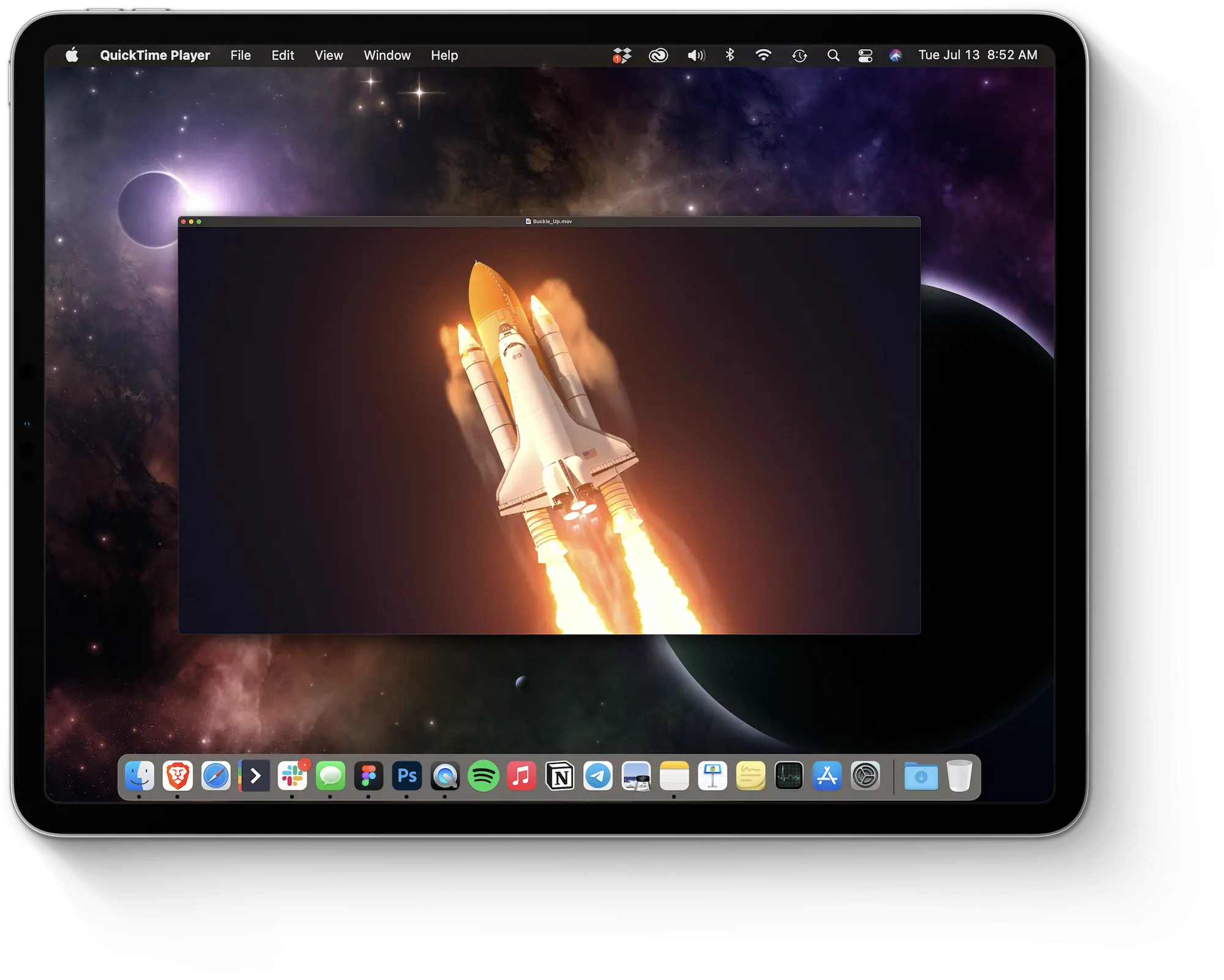 An iPad shows a video of a rocketship in space