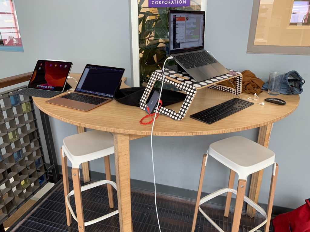 Giovanni's coworking space filled with multiple laptops.