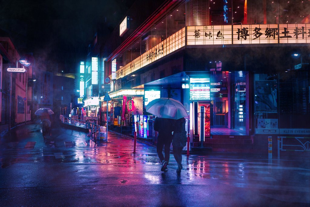 A dark and rainy street lite up by neon signs.