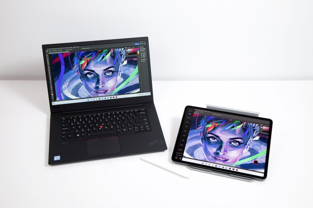 A PC laptop and an iPad next to each other with an illustration of a woman