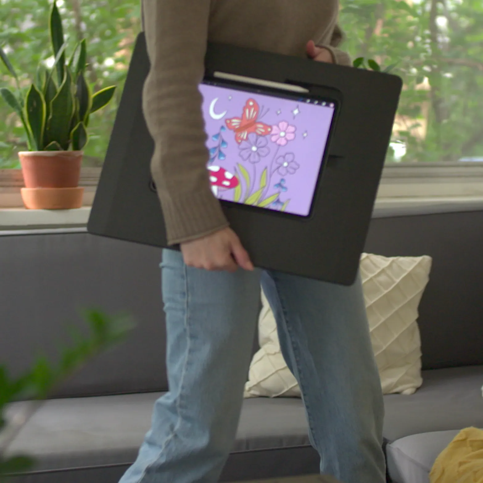 A woman walking with Darkboard at her side as the iPad displays an illustration of flowers