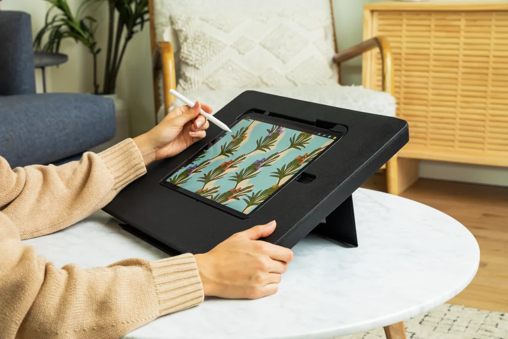 A person drawing on an iPad with the Darkboard iPad stand 