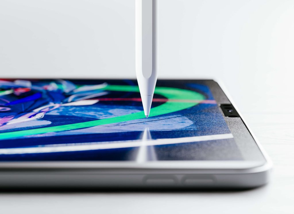 An Apple Pencil touching an iPad with a screen protector