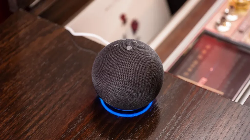 echo dot speaker sitting on a desk 