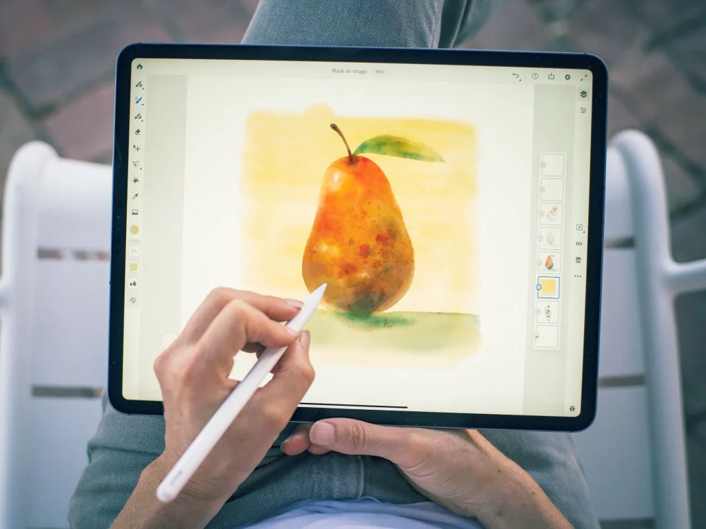 ipad with adobe fresco app open and a drawing of a pear on the screen 