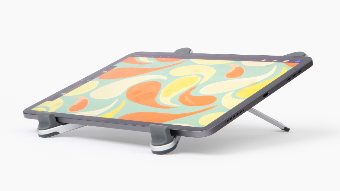 the compact easel with an ipad on it, showing colorful artwork on the screen 