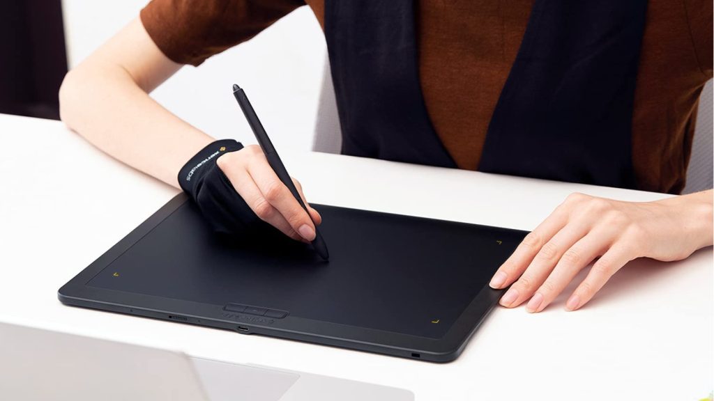 A person drawing on an iPad with a drawing glove 