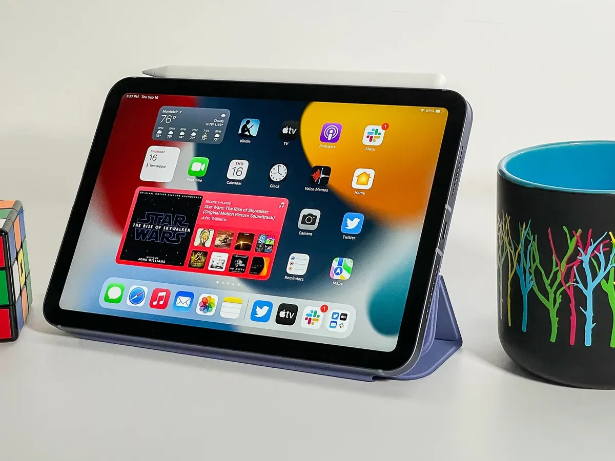 iPad Mini showing home screen. iPad is sitting next to a coffee cup. 