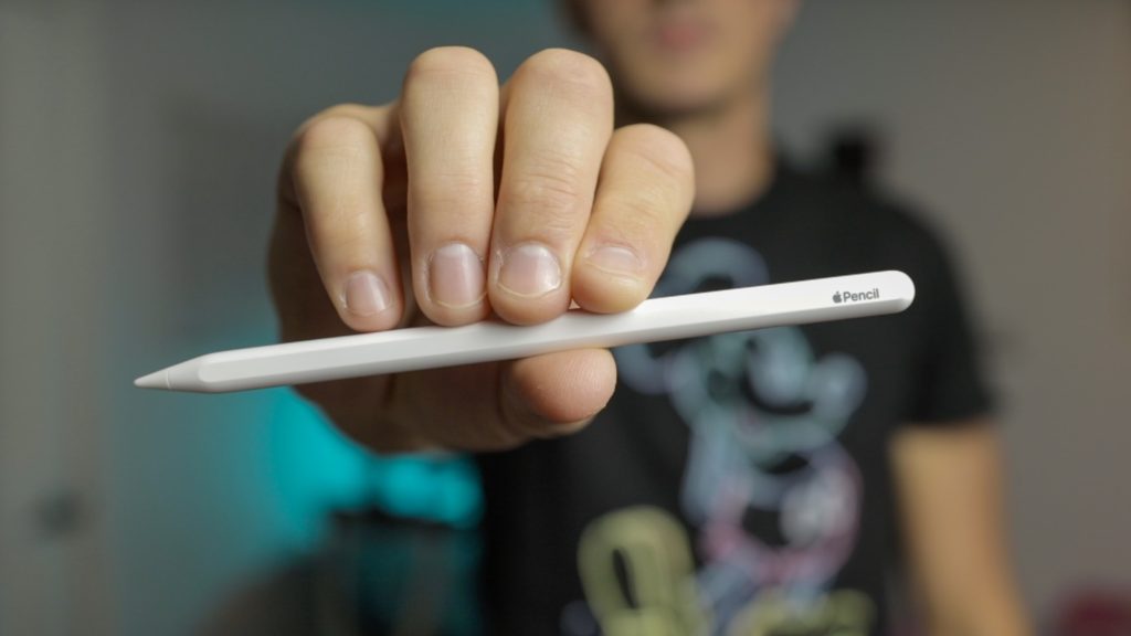 man holding Apple Pencil 2, showing a close up view of the flat edge 