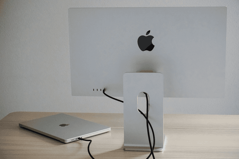 A MacBook connected to an iMac via Thunderbolt cable for Target Display Mode