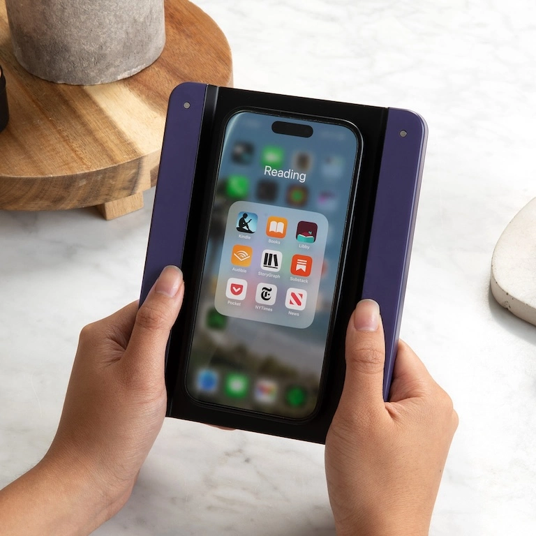 Hands holding the Bookcase product with an iPhone